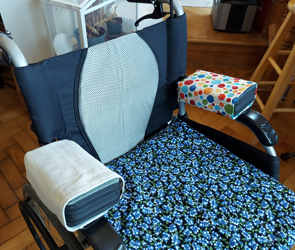 a wheelchair with fabric arm rest additions